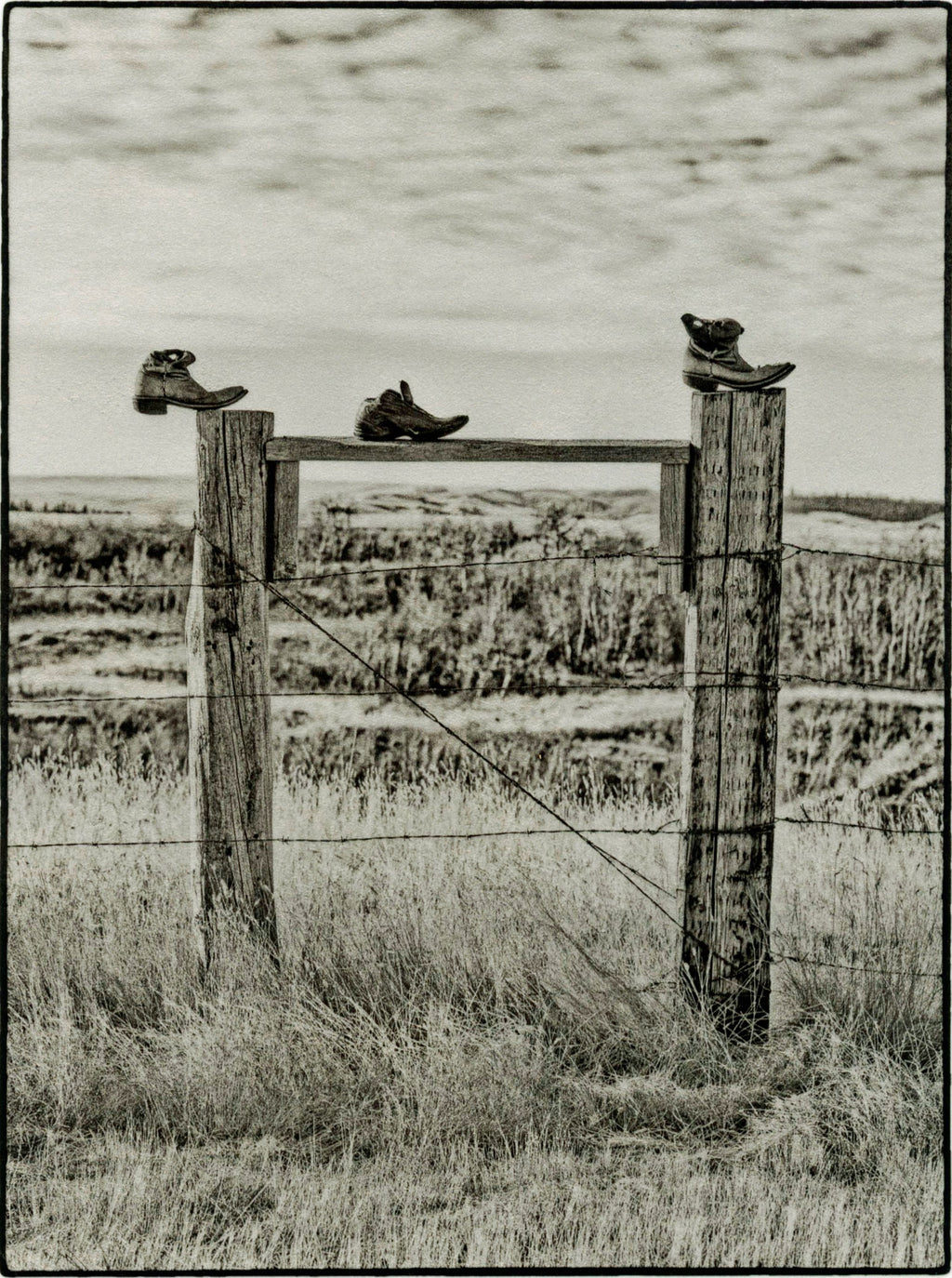 Three Boots on a Fence