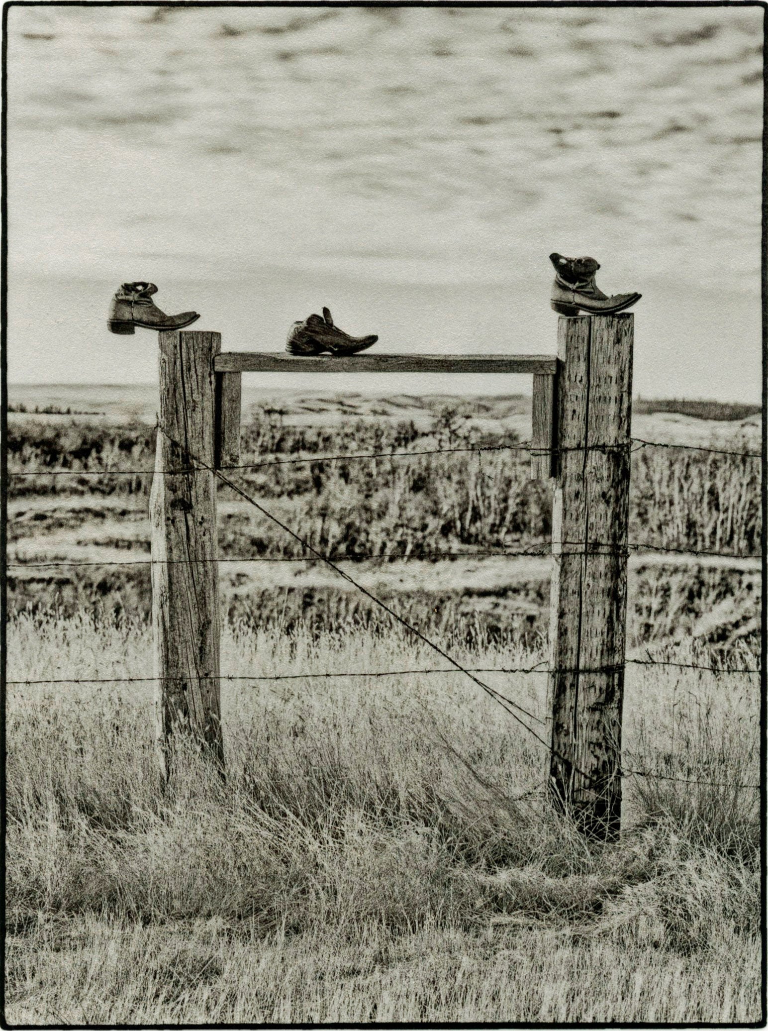 Three Boots on a Fence